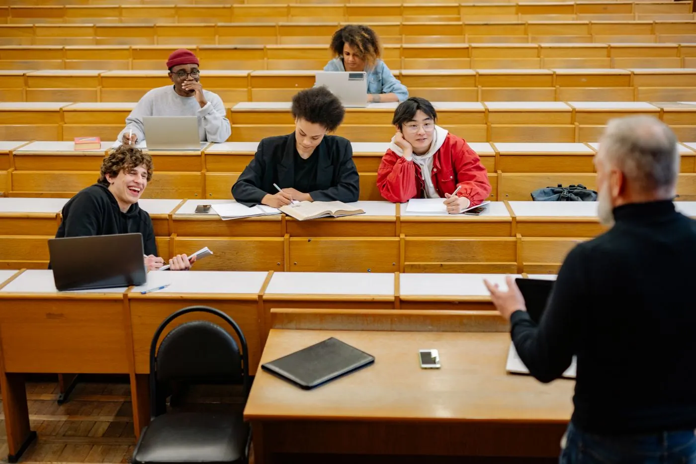 A lecturer teaching students in a college lecture hall