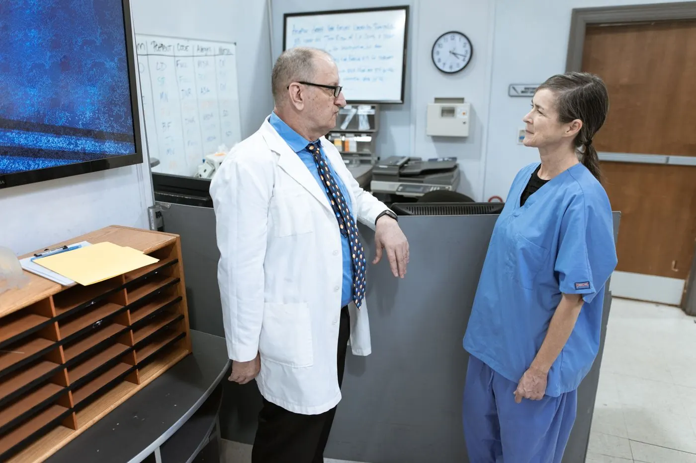 A doctor and nurse talking in a hospital